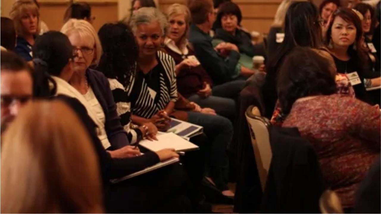 A large group of people are sitting in a room