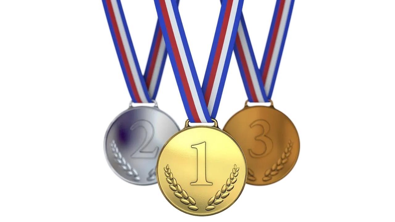 Three medals with the letter w on them