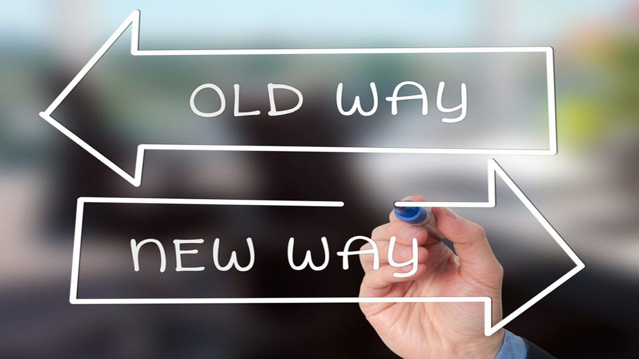 A person is writing old way and new way with a marker