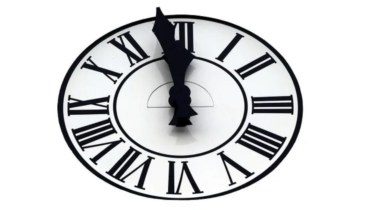 A black and white clock with roman numerals on it