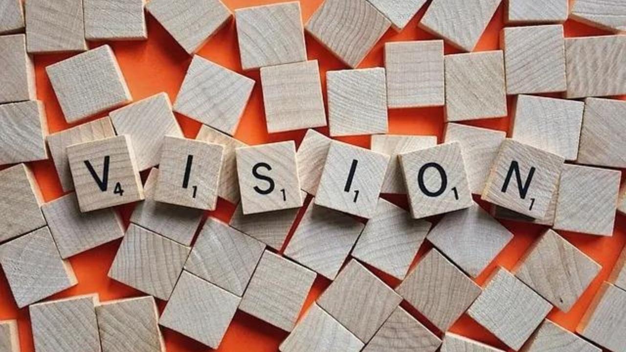 The word vision is written on wooden scrabble tiles.