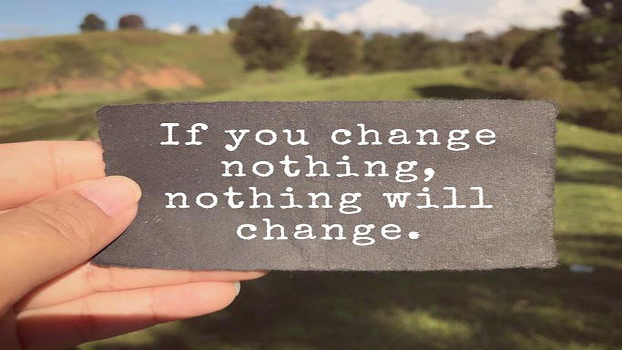 A person is holding a piece of paper that says `` if you change nothing , nothing will change . ''