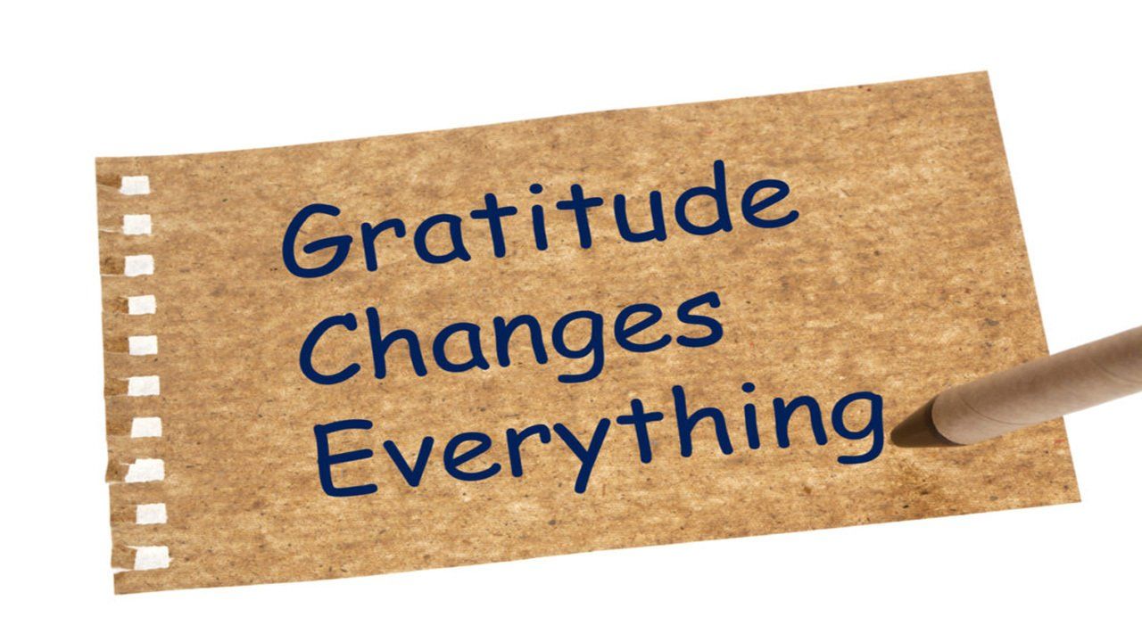 A piece of paper with the words gratitude changes everything written on it