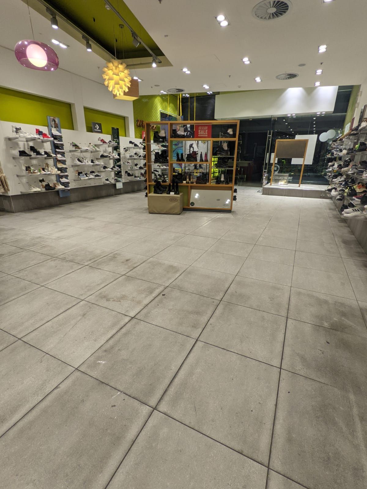Retail shoe shop in London shopping centre โ deep cleaned porcelain tiles and grout, removing dirt buildup for a like-new finish.
