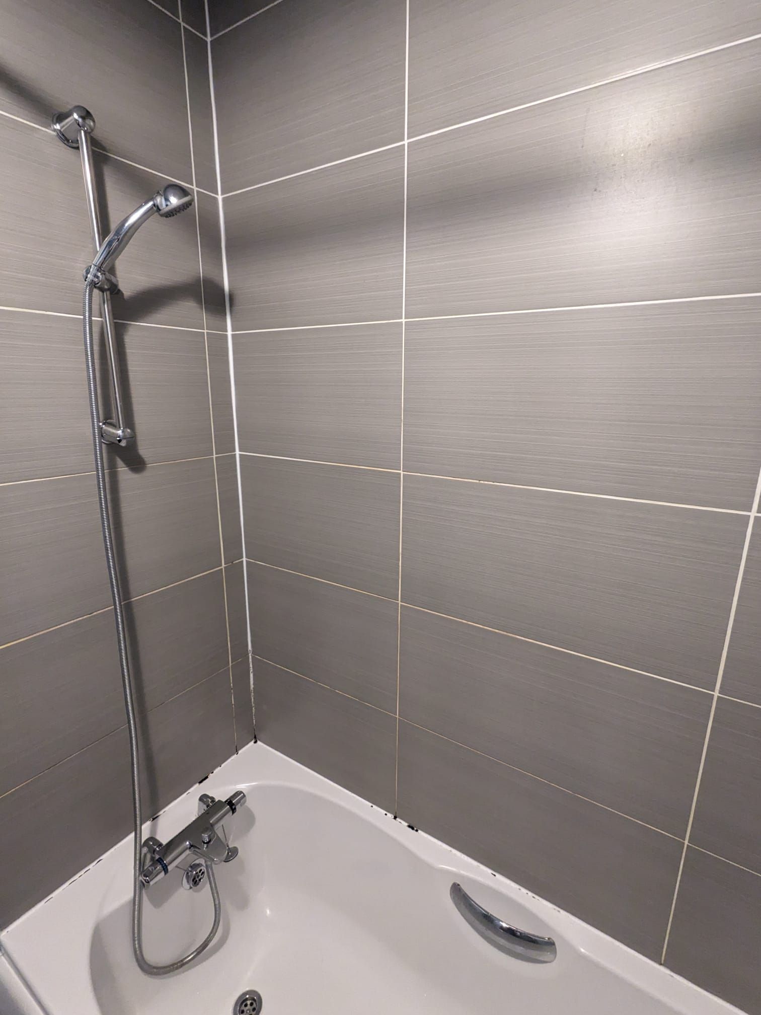 SHOWER AND BATH AREA RESTORATION with mouldy silicone sealant and dicoloured grout IN MANCHESTER, GREATER MANCHESTER