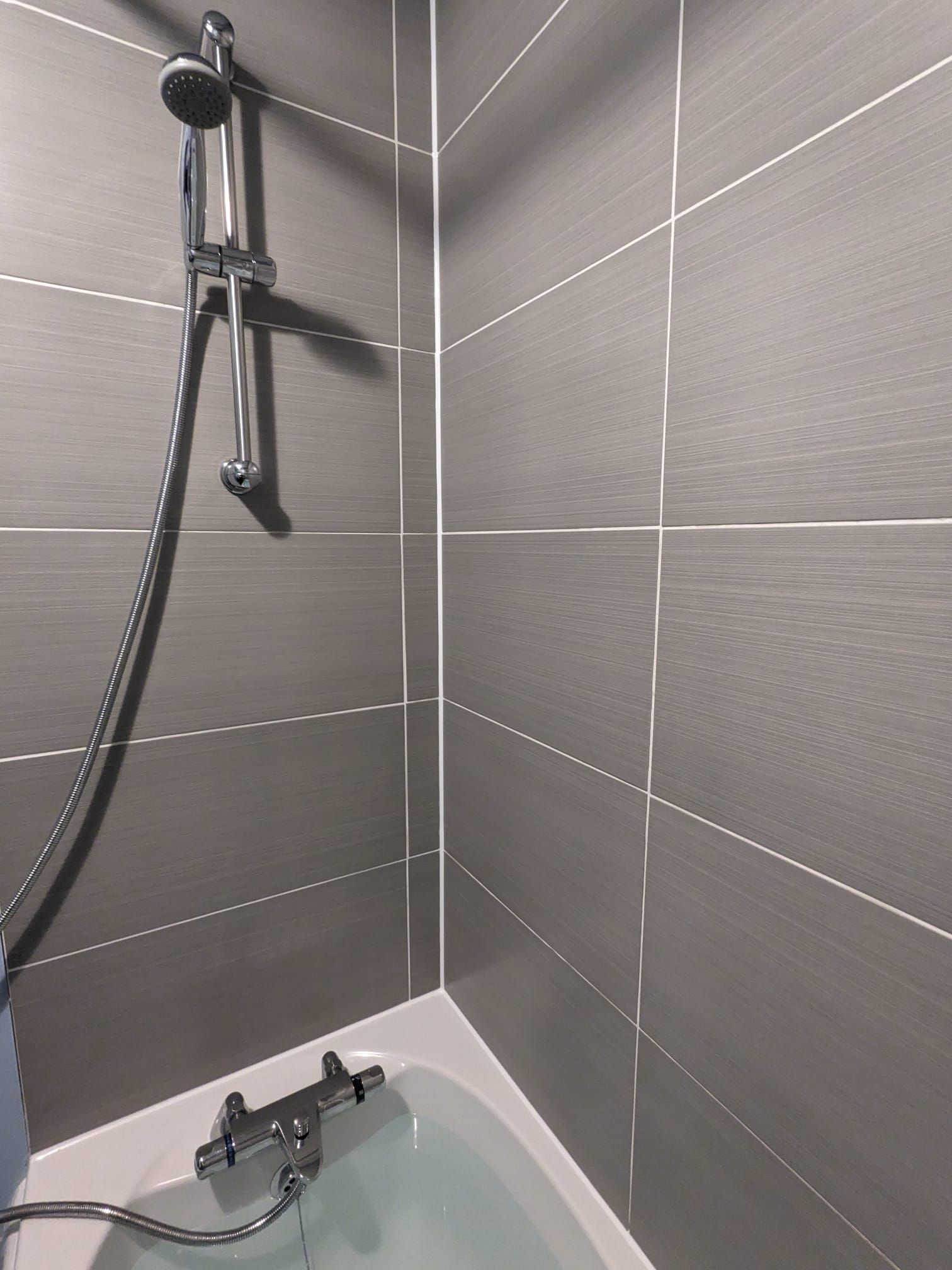 SHOWER AND BATH AREA RESTORATION with mouldy silicone sealant and dicoloured grout IN MANCHESTER, GREATER MANCHESTER