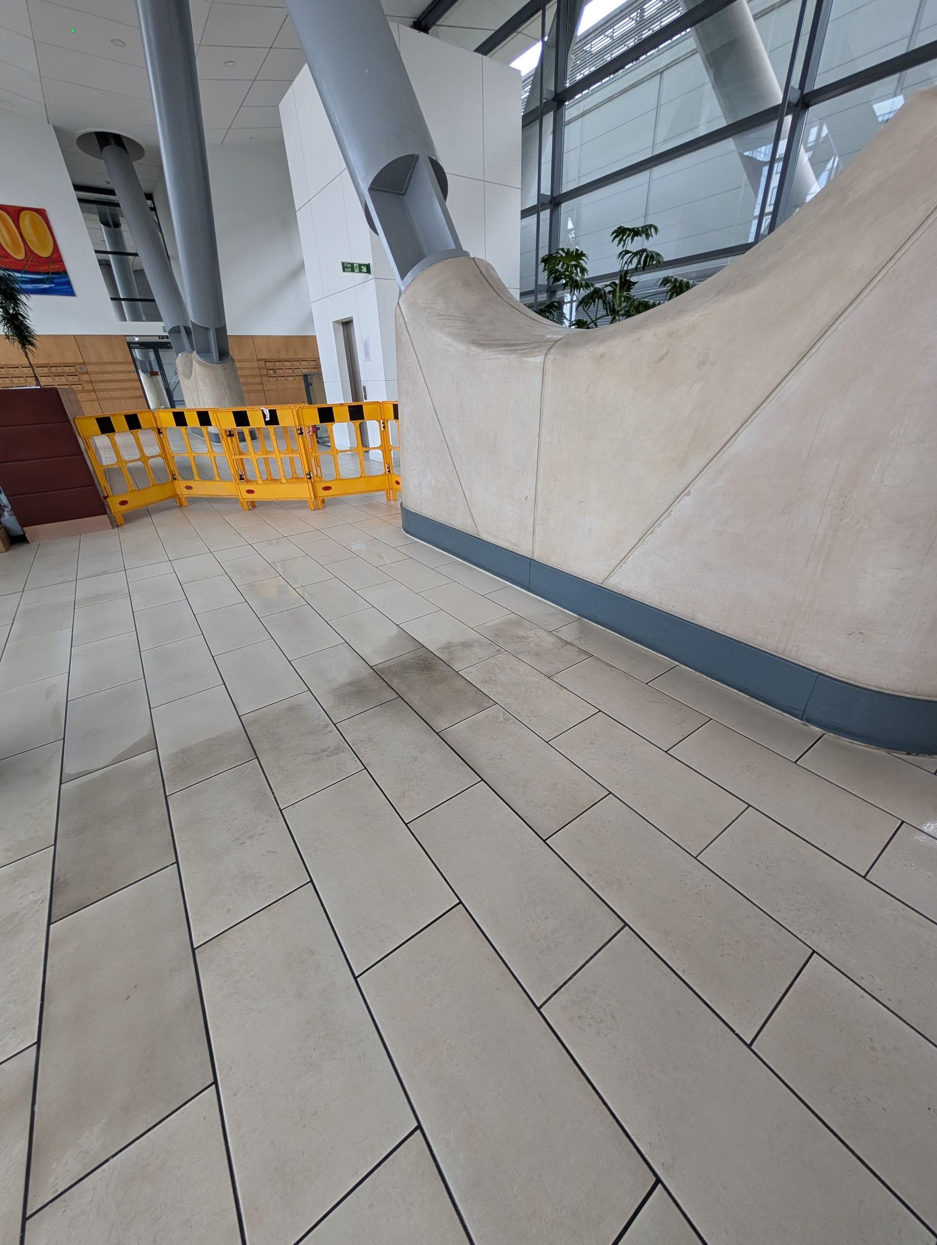 Before and after of communal lobby after tile professional tile cleaning by Quality Tile Care