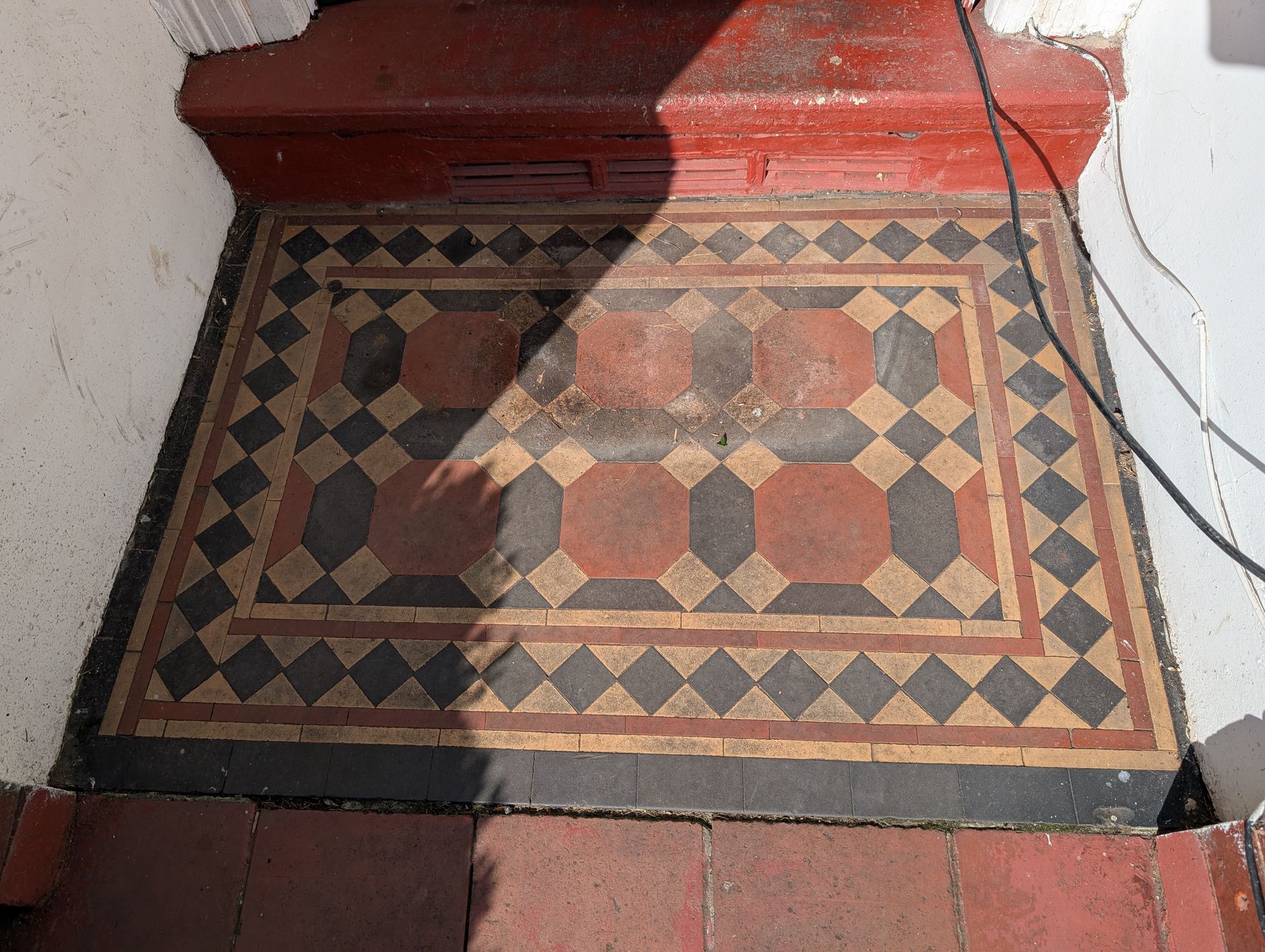 Victorian tiled porch floor restoration deep cleaning sealing in Chorlton, Greater Manchester. We are based in Hindley, Wigan, but cover also Liverpool, Lancashire and Derbyshire areas. Before photo. 
