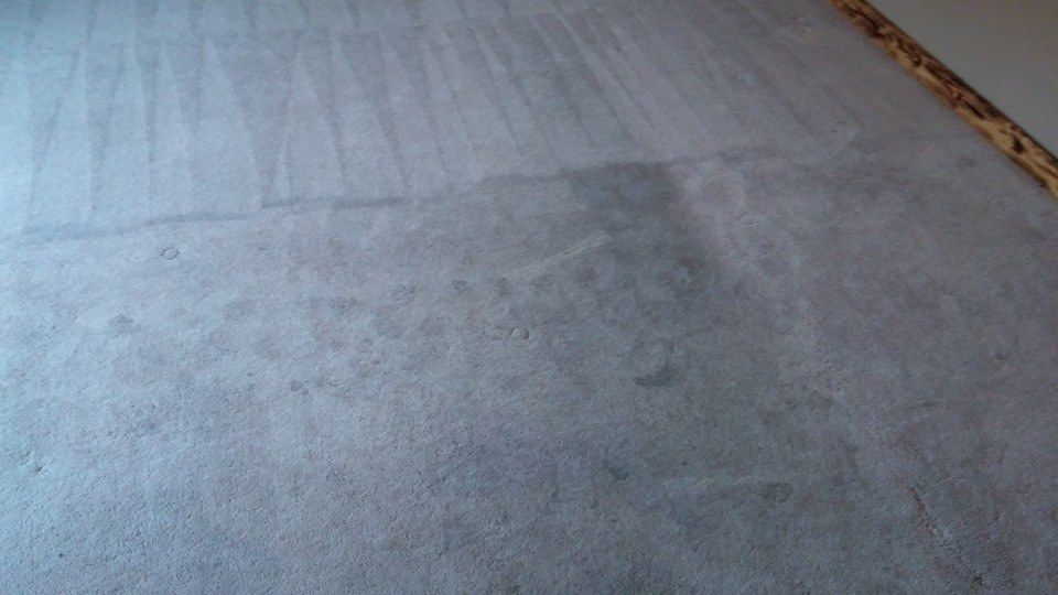 A close up of a white carpet in a room.