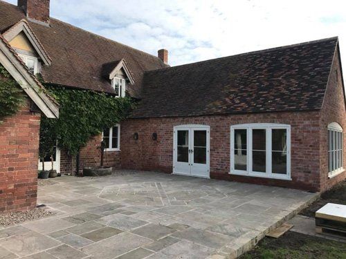paved outdoor space and extension on large home