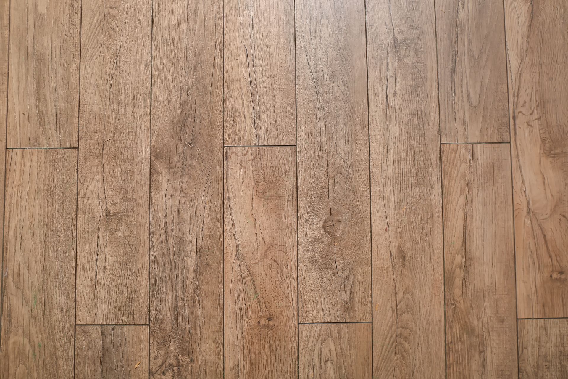 Light brown wooden plank flooring with vertical grain patterns Light brown wooden plank flooring with vertical grain patterns