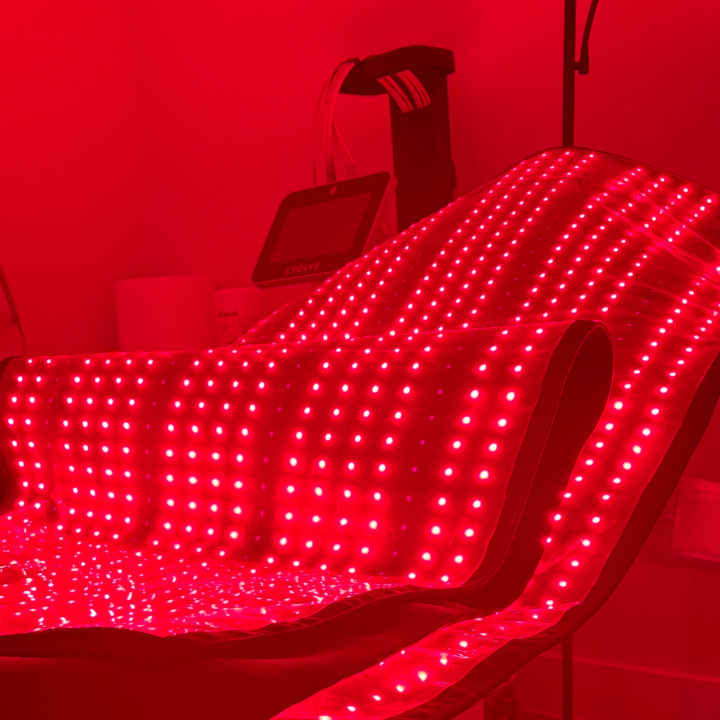 Red light therapy bed with numerous red LED lights.