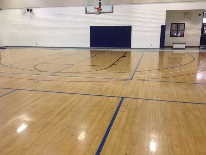 An empty basketball court with a wooden floor