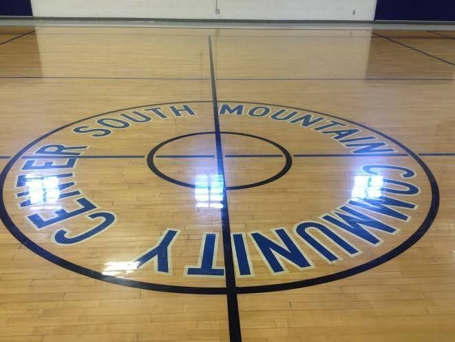 A basketball court with the south mountain community center logo on it