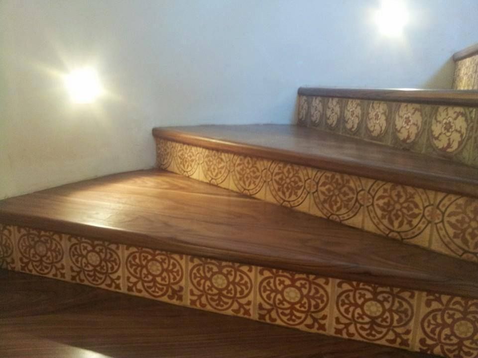 A close up of a wooden staircase with a pattern on the steps.