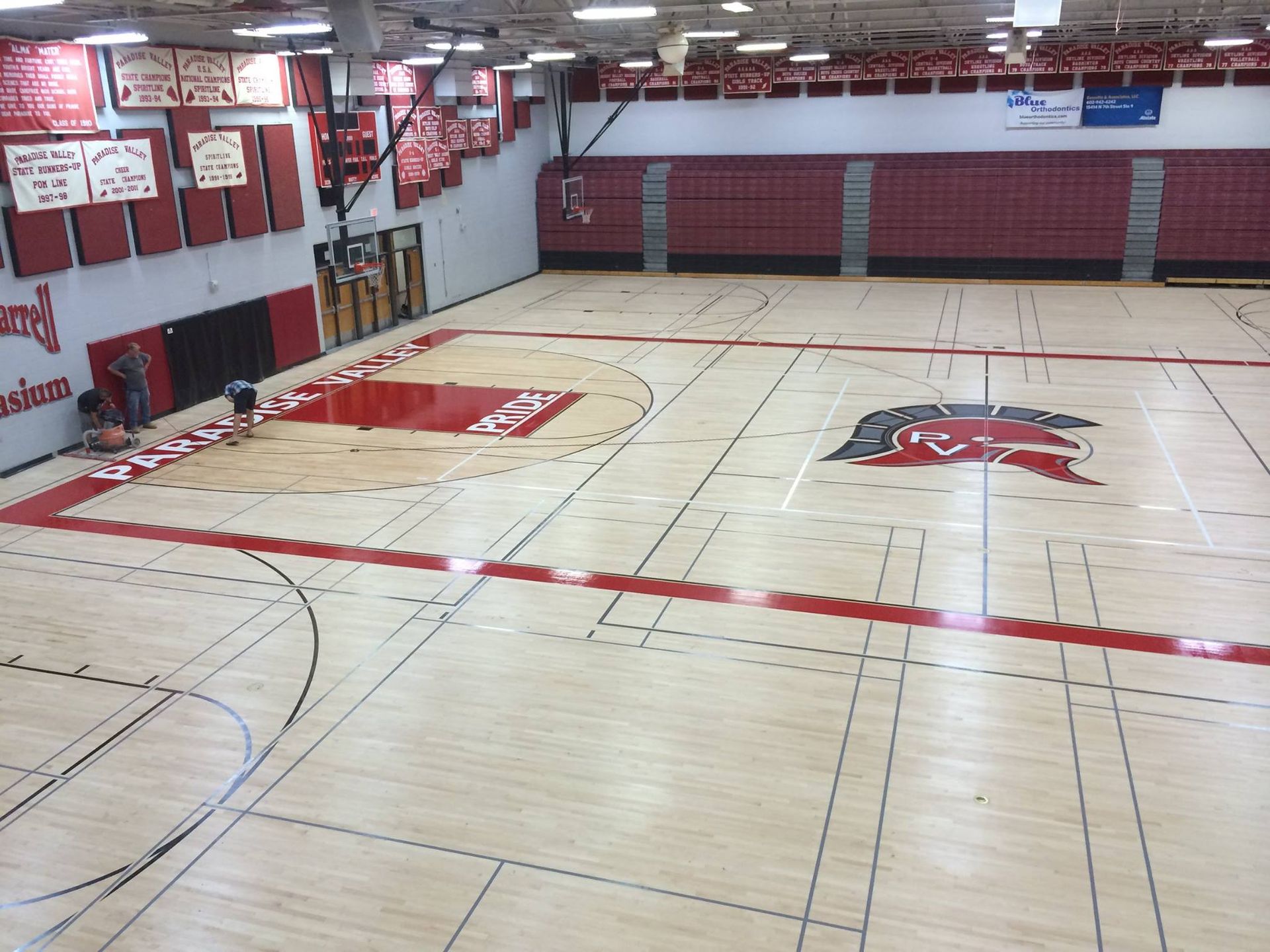 A basketball court with a logo on the floor that says ' arkansas '