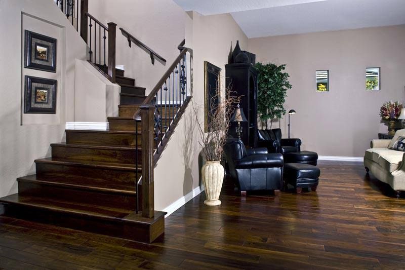 A living room with stairs leading up to the second floor
