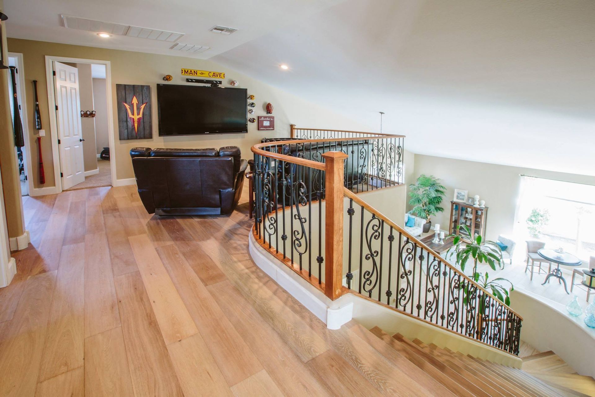 A living room with hardwood floors and stairs leading up to the second floor.
