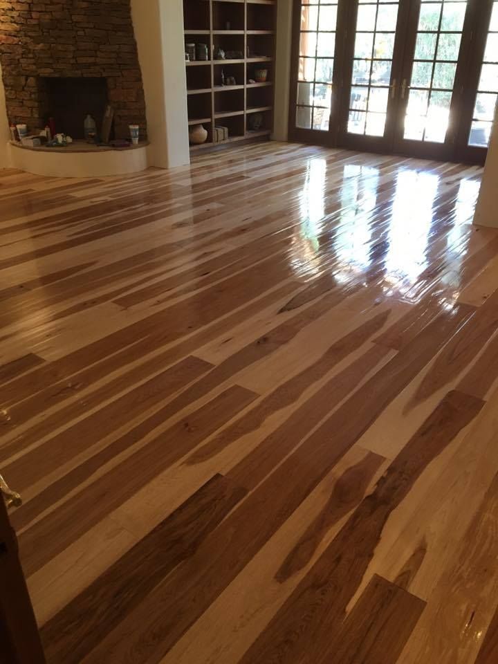 A living room with hardwood floors and a fireplace