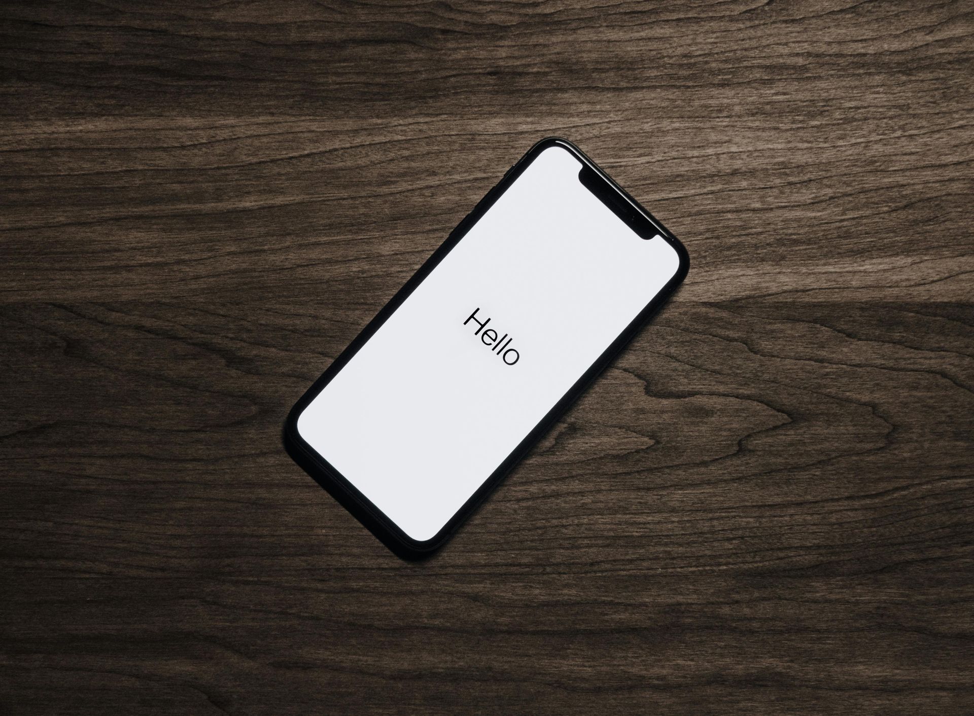 A smartphone displaying the word 'hello,' representing social media video content strategy and client engagement.