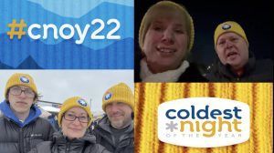 People wearing yellow hats with a logo participate in the Coldest Night of the Year fundraiser, with a blue and yellow logo.