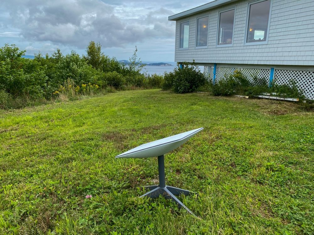 Small Satellite Dish on a Tripod in a Grassy Yard — Boardman's TV Antennas in Basin View, NSW