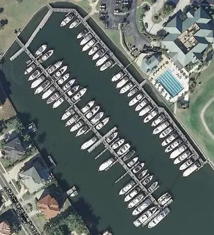 An aerial view of a marina with many boats docked.