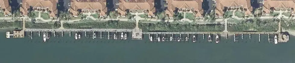 An aerial view of a dock with boats in the water.