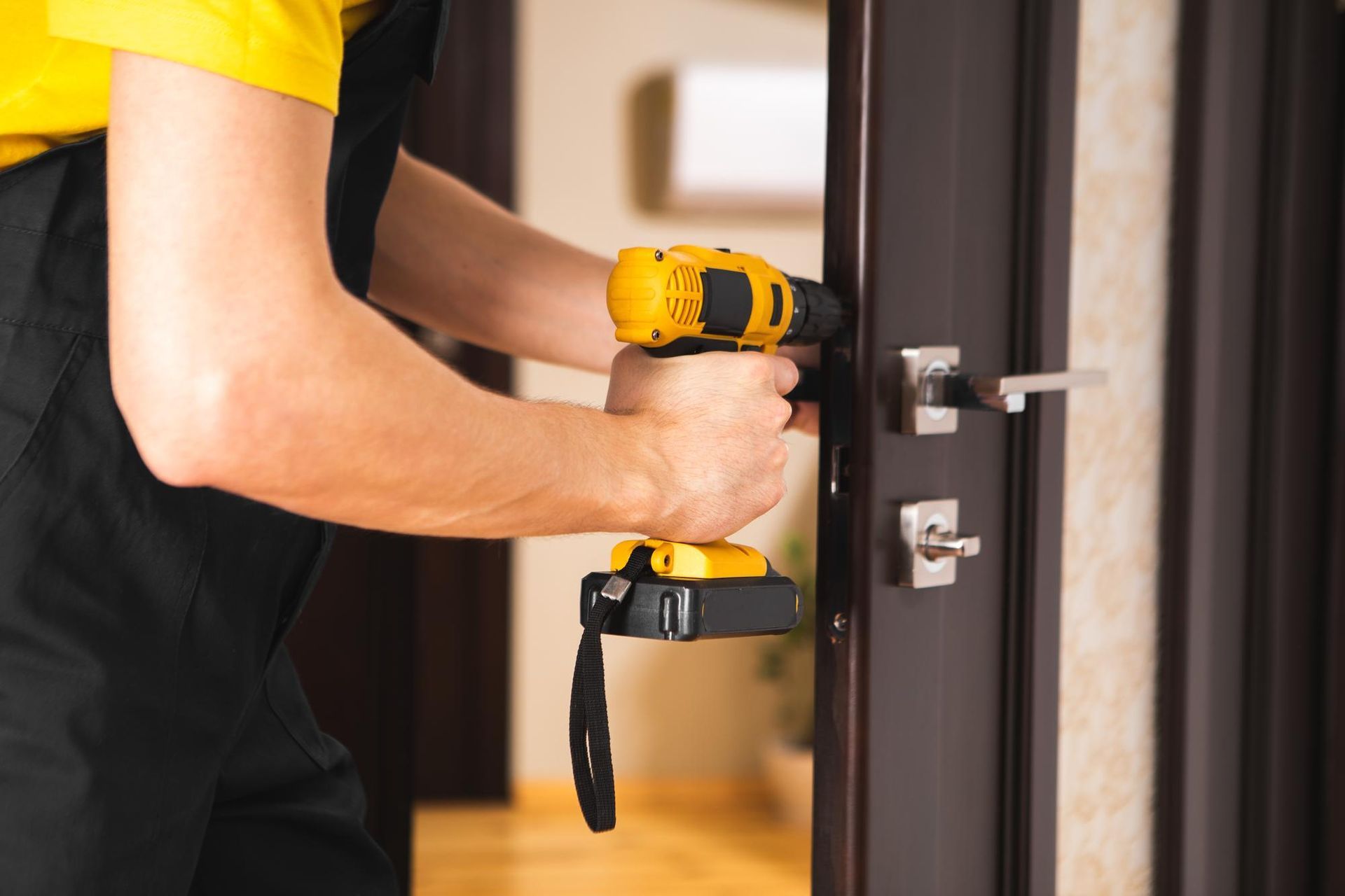 a man is fixing a door with a drill