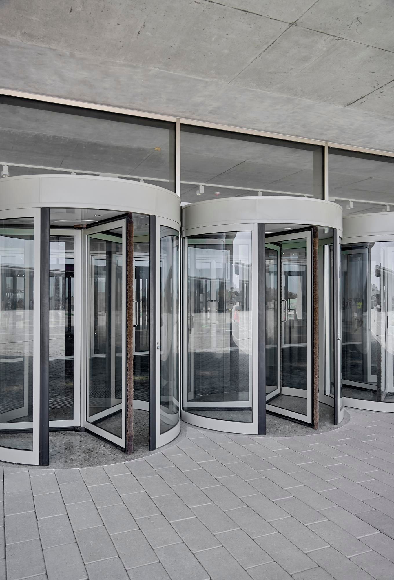 a building with a lot of glass doors and a concrete floor