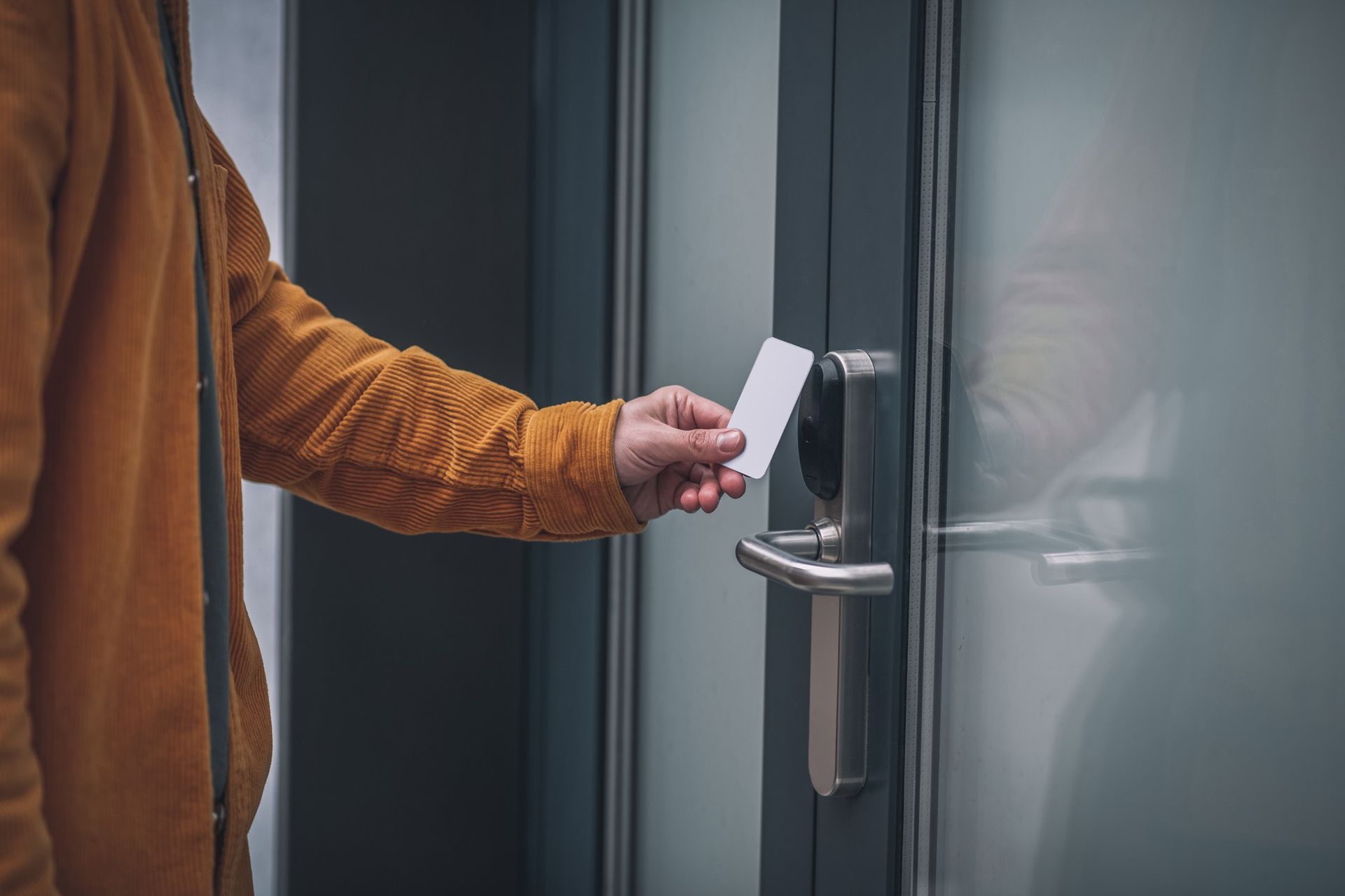a man is using a key card to open a door