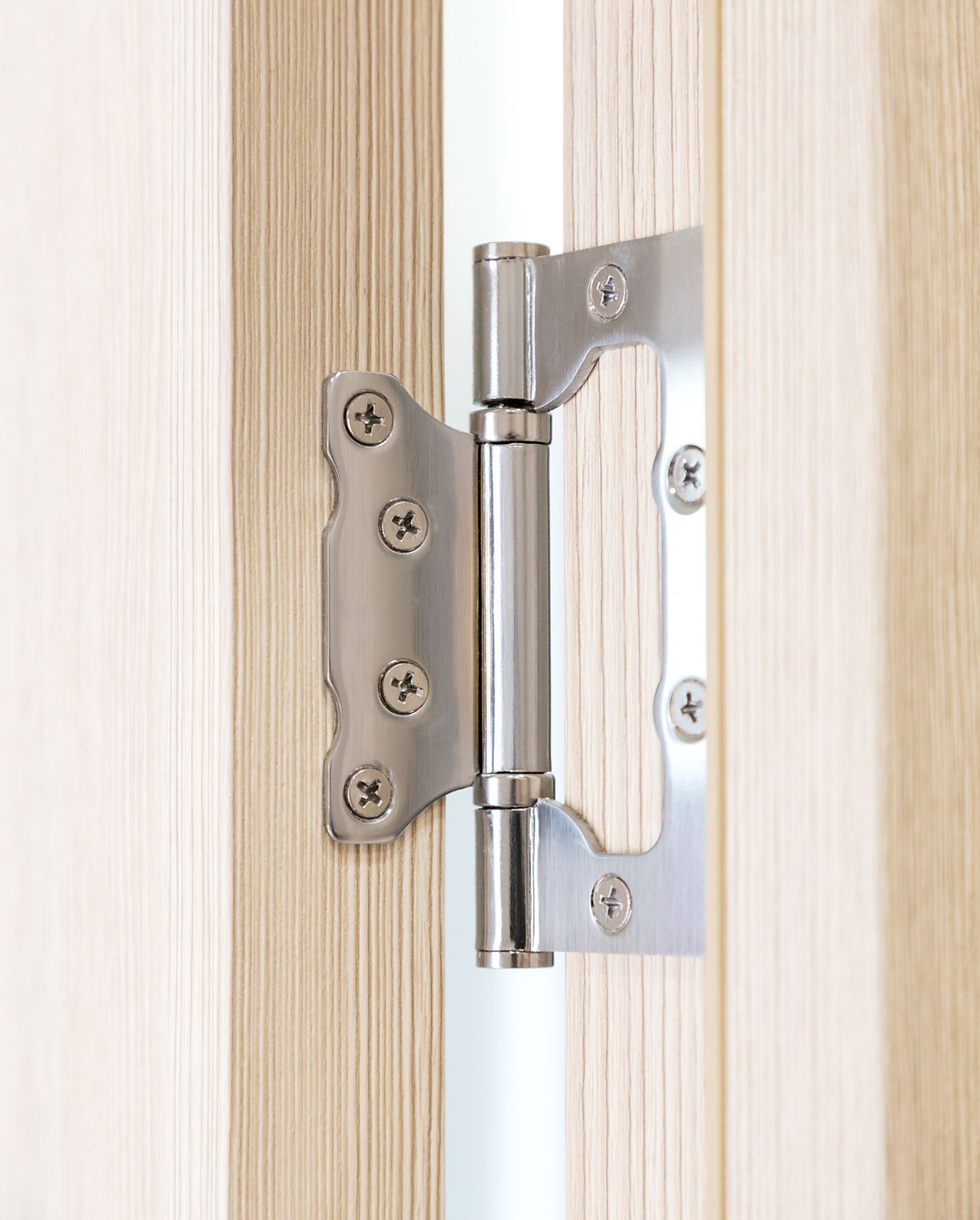 a close up of a door hinge on a wooden door