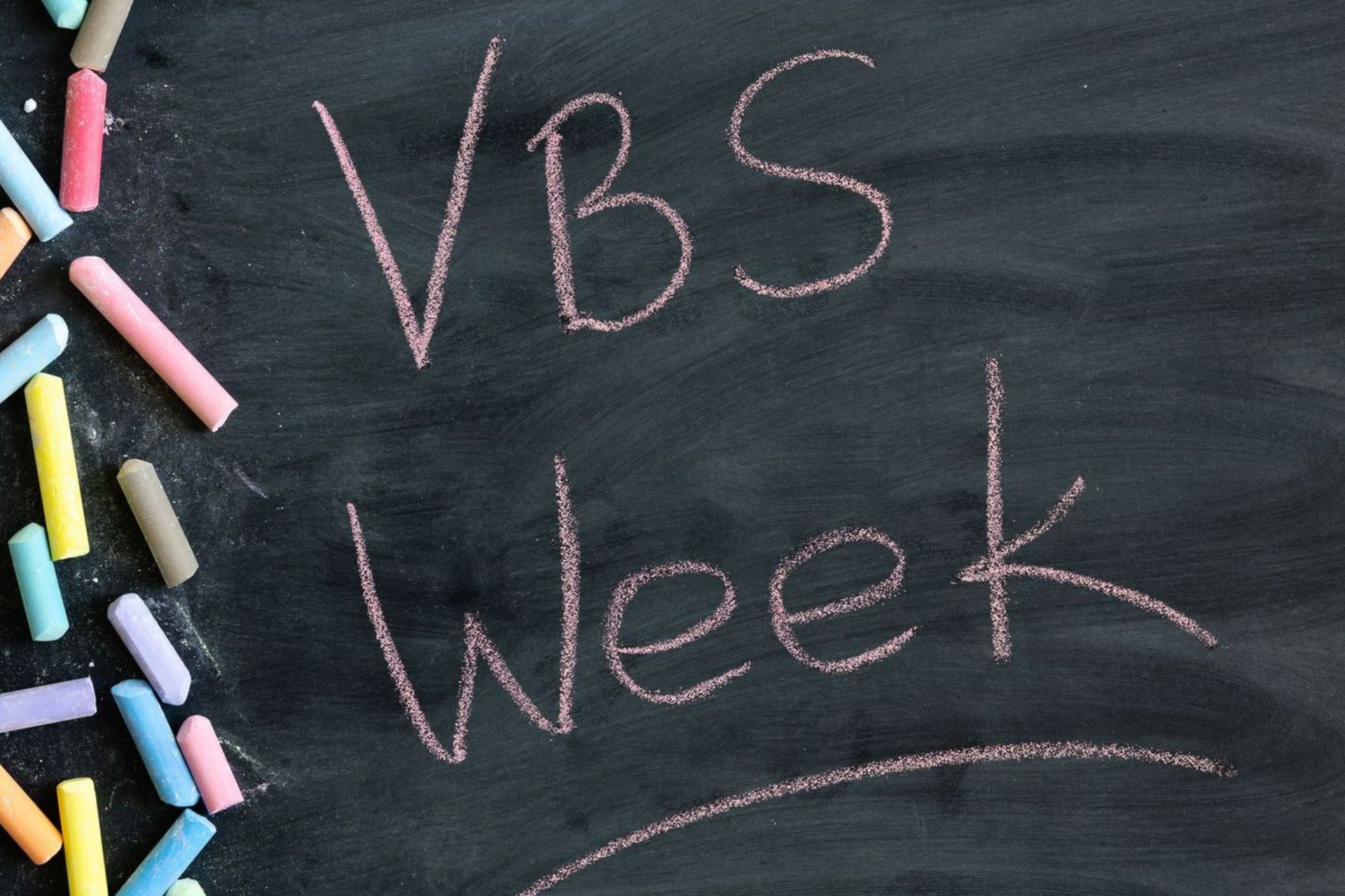 A chalkboard with the words vbs week written on it
