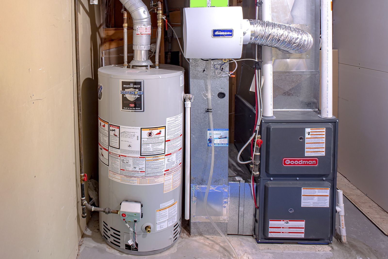 A water heater and an air conditioner are in a basement.