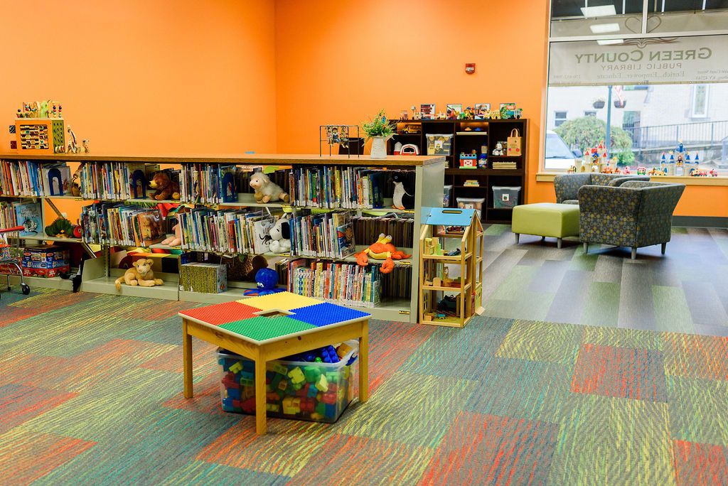 An orange playroom with toys and games