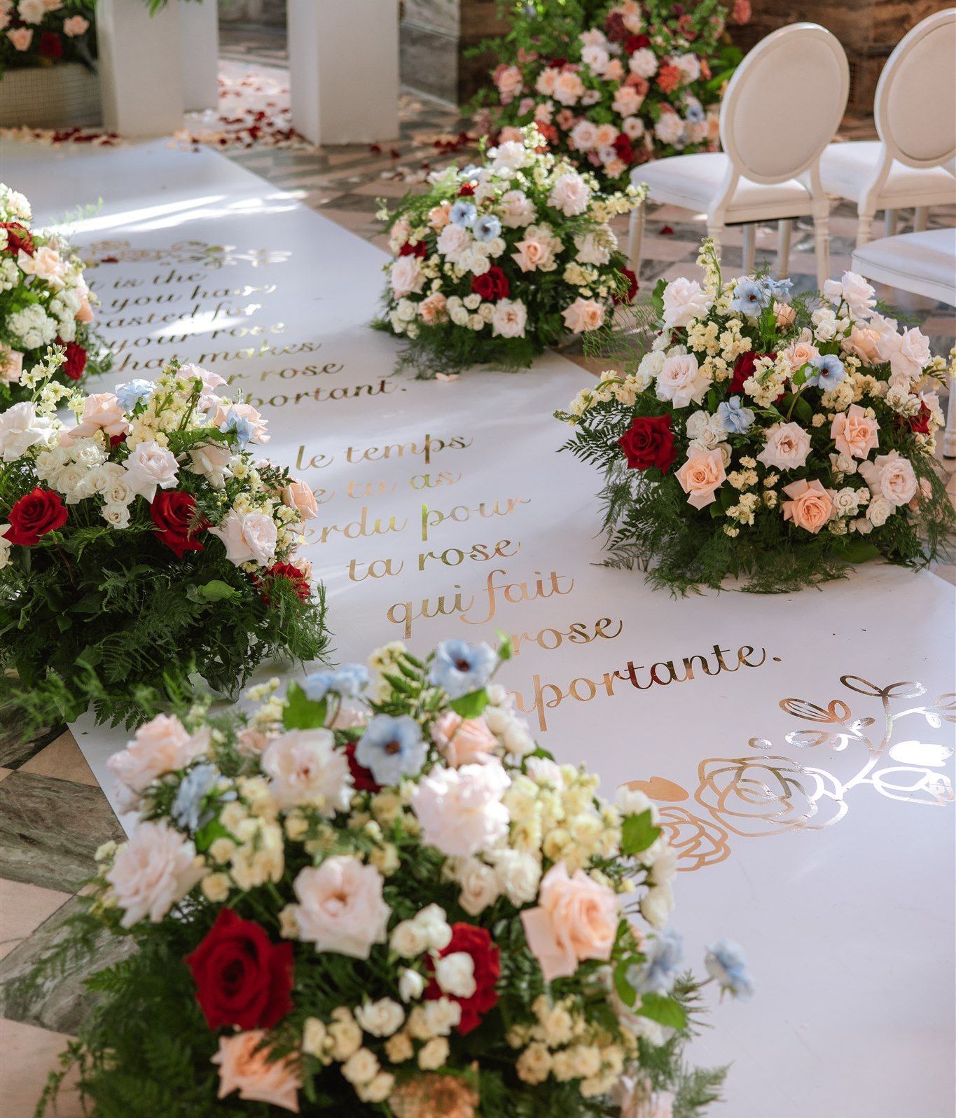 A row of bouquets of flowers on a white carpet