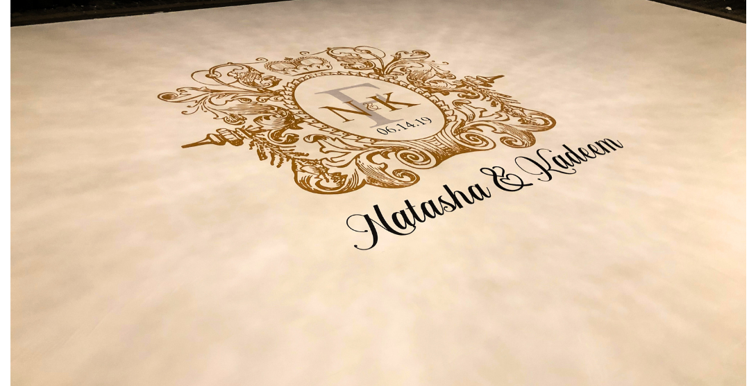 A wedding dance floor with a logo and the names of the bride and groom on it.
