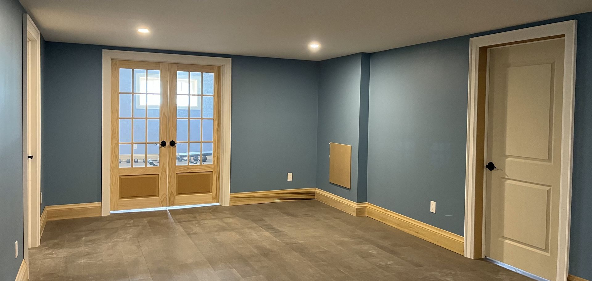 a room with a door and a wood floor