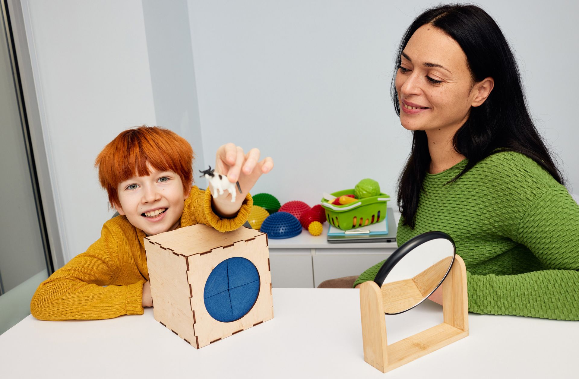 A kid's psychologist working with a child in the office, showcasing ABA services. A kid's psychologist working with a child in the office, showcasing ABA services.