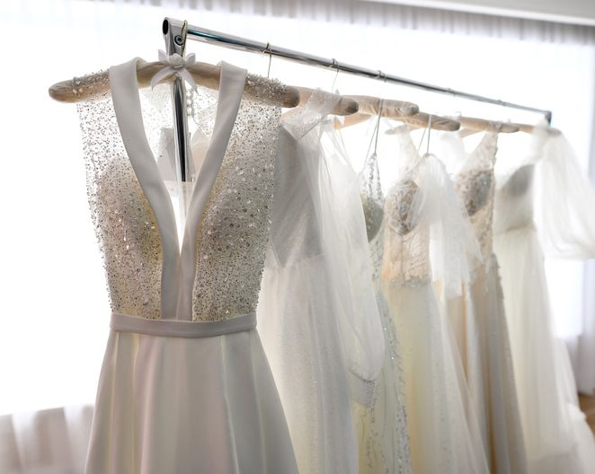 Wedding dresses hang on hanger in the wedding showroom