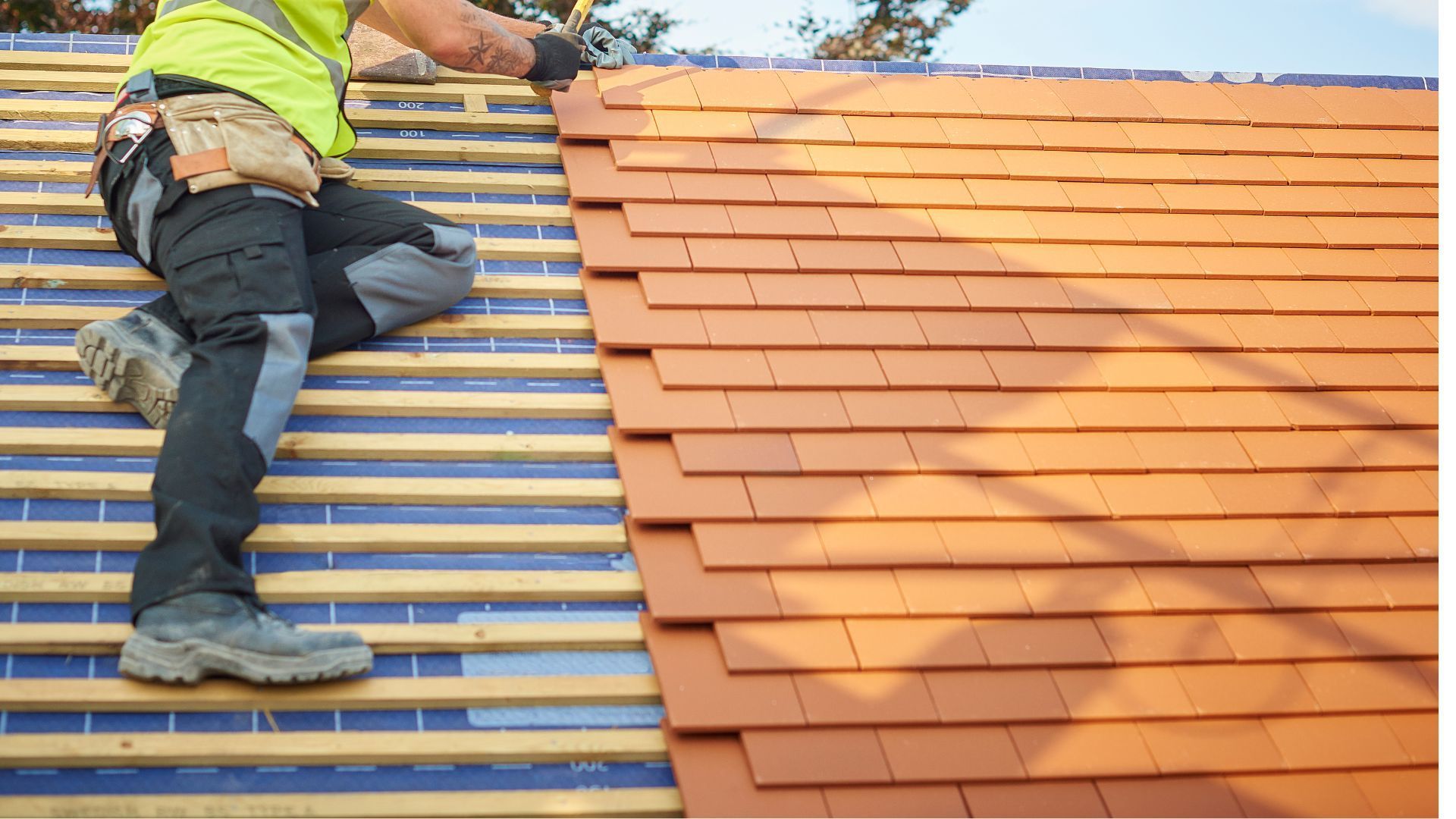 A man is sitting on top of a roof.