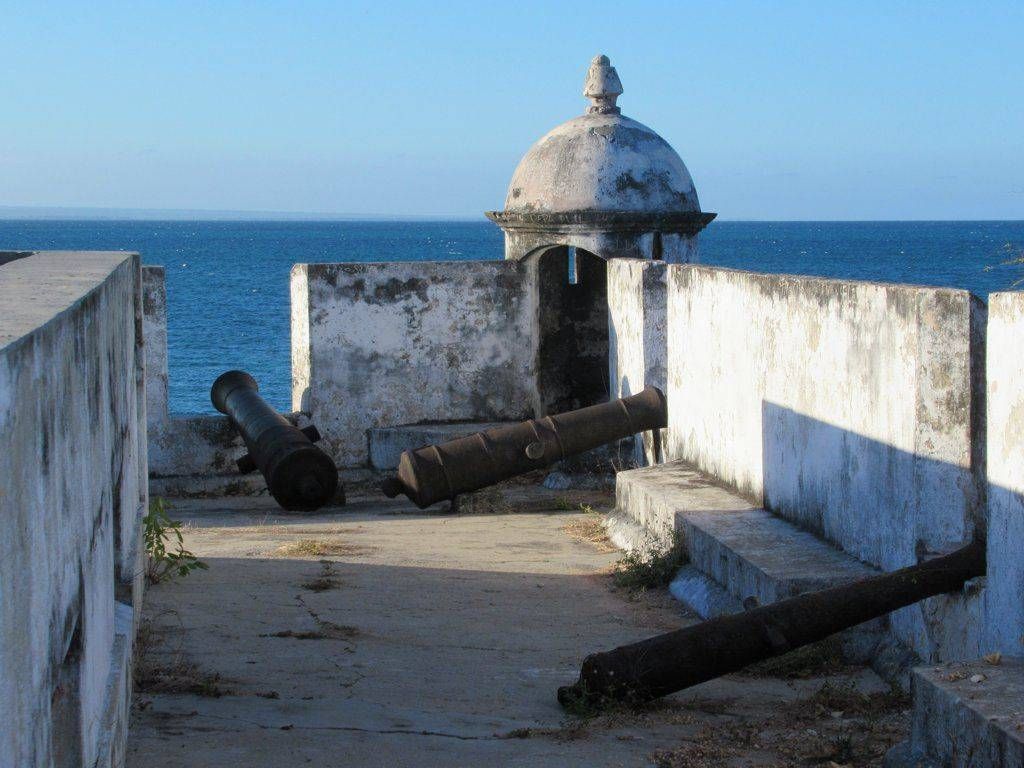 Stone fort corridor with old cannons overlooking the blue ocean
