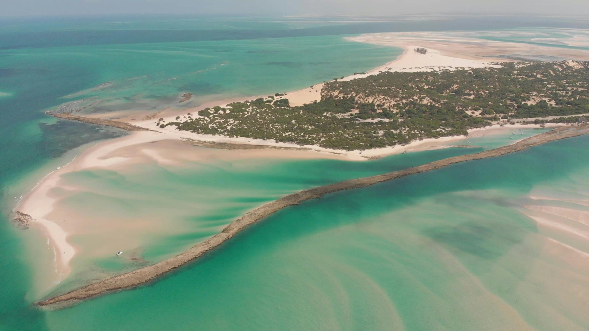 Aerial view of a tropical island with white sandbars and turquoise water.