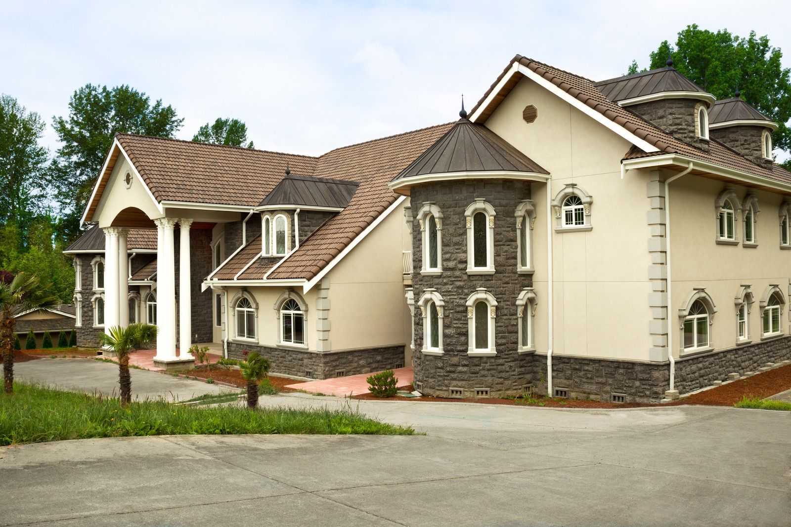 A large house with a brown roof and a lot of windows