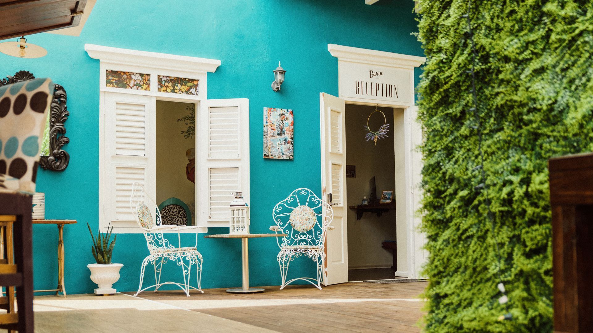 Colorful turquoise entrance of Bario Hotel in Otrobanda, welcoming Caribbean architecture in Curaçao