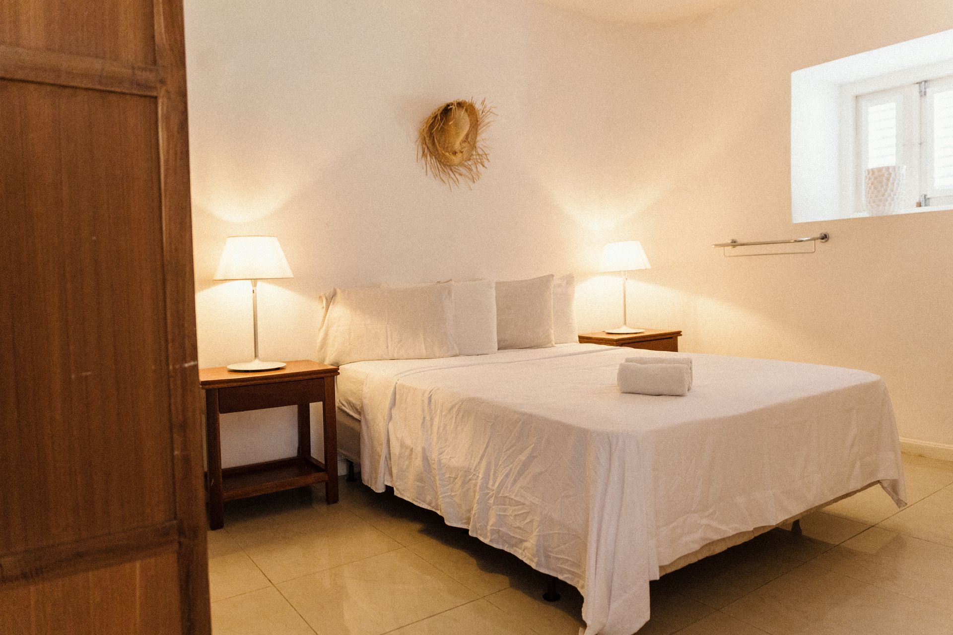 Spacious two-bedroom apartment with warm lighting and comfortable beds at Bario Hotel Curaçao