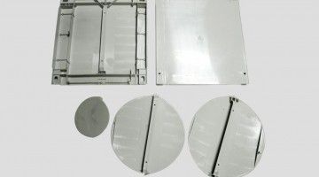 A group of plastic plates and circles on a white surface.