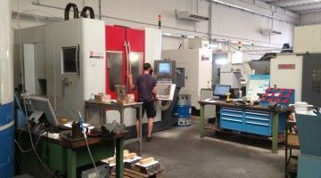 A man is working on a machine in a factory.