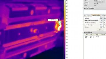 A thermal image of a building next to a computer screen.