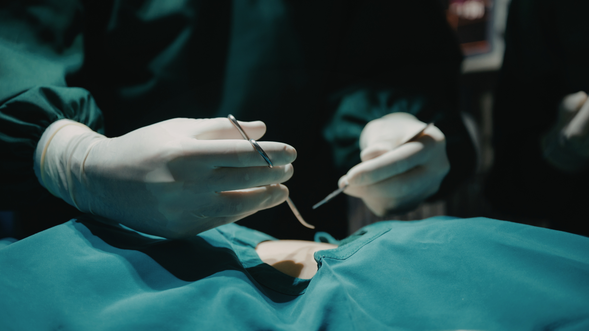 Person's foot being examined by a gloved person, likely during a foot care procedure.